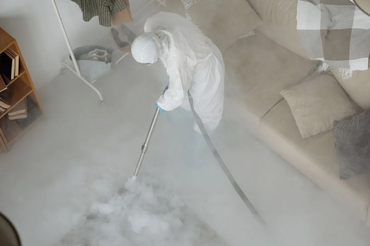 Biohazard cleanup technician in protective equipment, East Hampton, NY